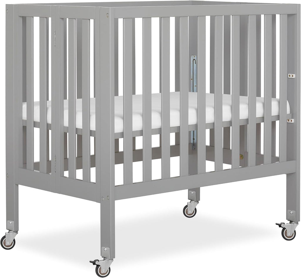 Dream On Me Jett Mini Folding Baby Crib in Pebble Grey, GreenGuard Gold & BSA, Lightweight & Portable, Patented Flat Folding System, Small Spaces & Travel, 1.5” Mattress Pad, 3 Heights, Safe Wheels