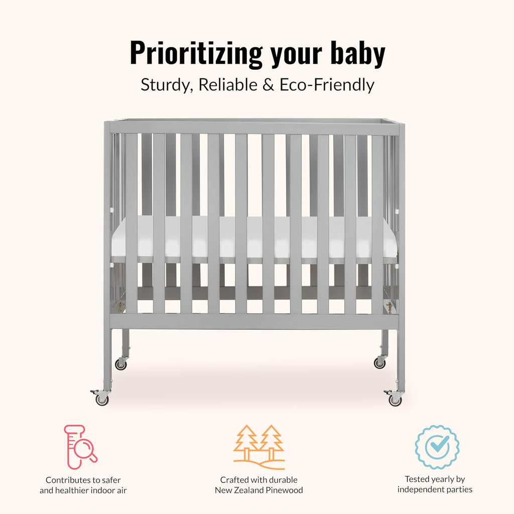Dream On Me Jett Mini Folding Baby Crib in Pebble Grey, GreenGuard Gold & BSA, Lightweight & Portable, Patented Flat Folding System, Small Spaces & Travel, 1.5” Mattress Pad, 3 Heights, Safe Wheels